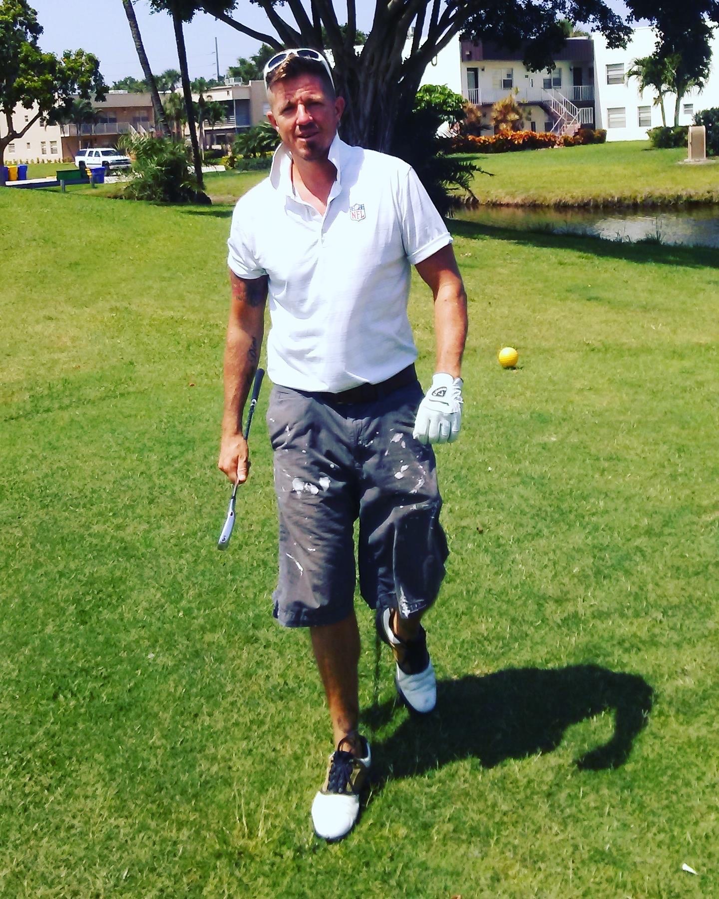 Brian walking on a golf course