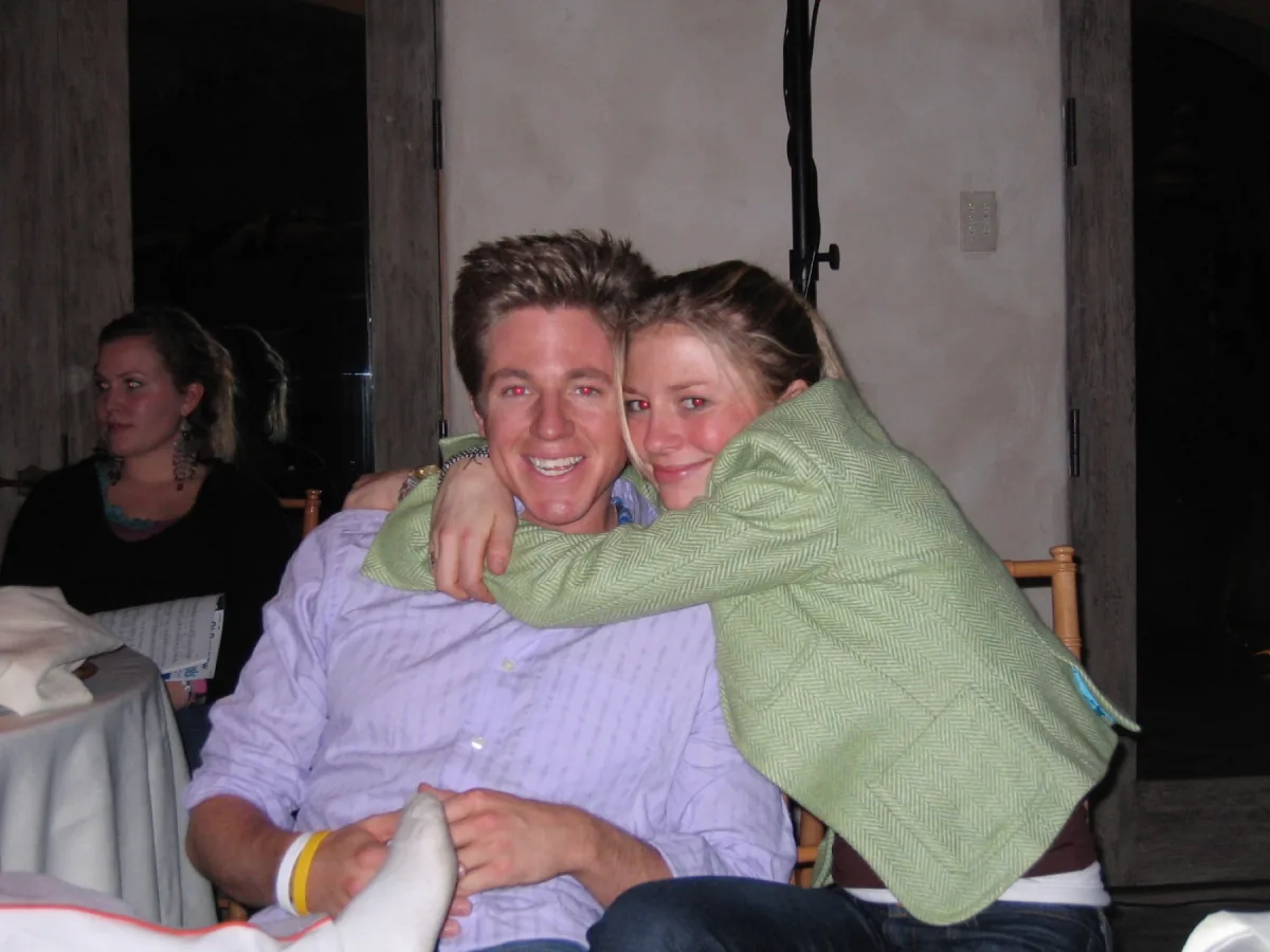 Brian Vulbrock smiling while being hugged at a gathering