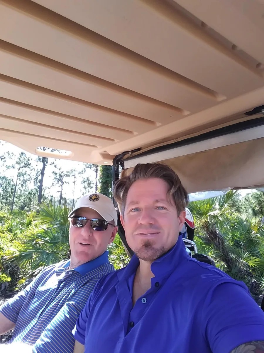 Brian Vulbrock riding in a golf cart with family